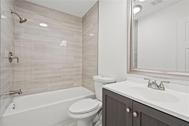 full bathroom with vanity, toilet, and tiled shower / bath combo