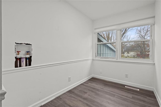 unfurnished room with wood-type flooring