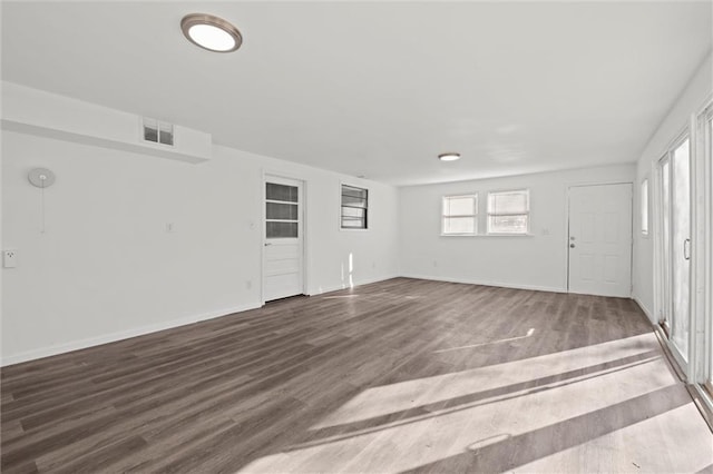 interior space with visible vents, baseboards, and wood finished floors