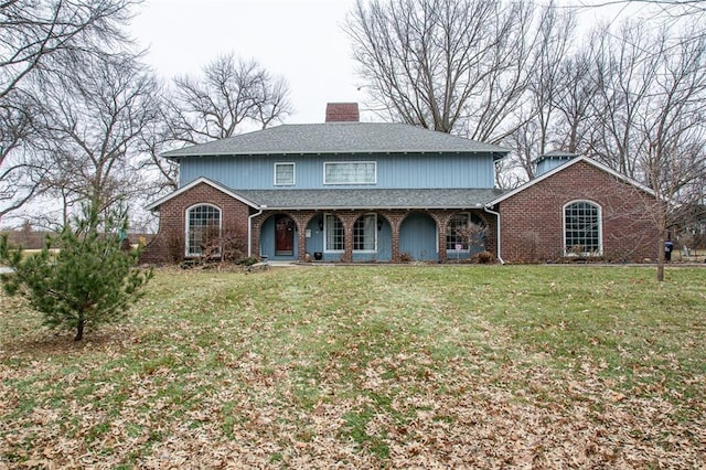 front facade with a front yard and covered porch