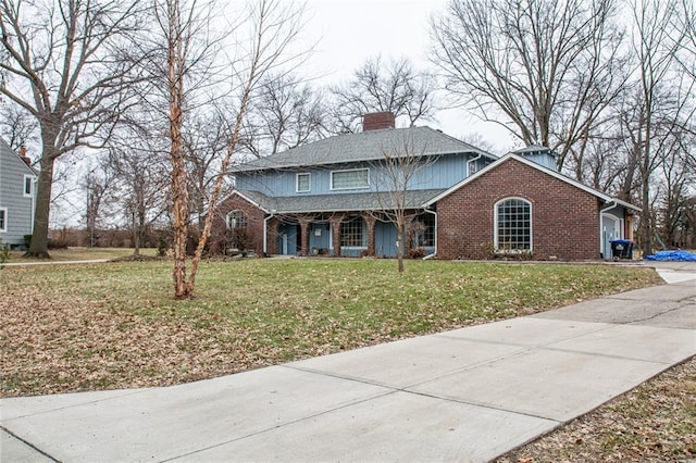 front of property with a garage, covered porch, and a front yard