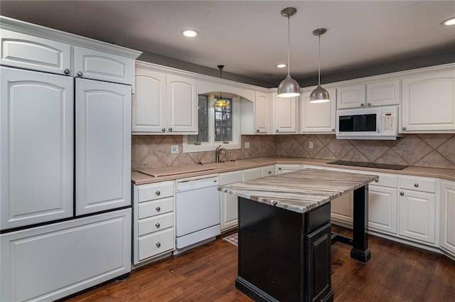 kitchen featuring sink, white appliances, white cabinets, a kitchen island, and decorative light fixtures