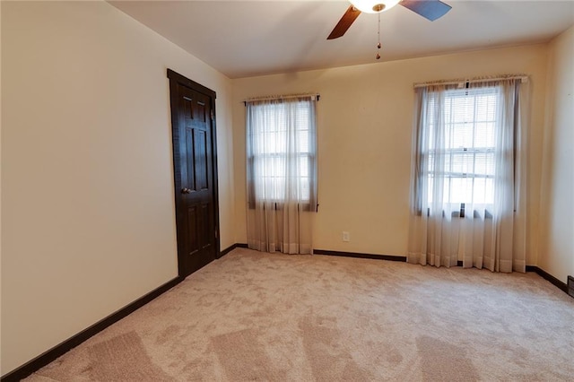 carpeted empty room featuring ceiling fan