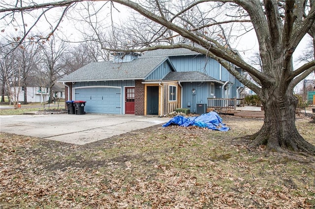 view of front of property with a wooden deck, a garage, and central air condition unit