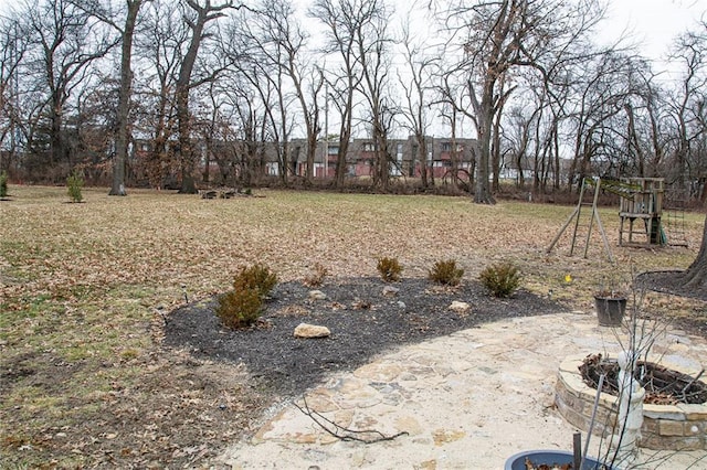 view of yard featuring an outdoor fire pit and a playground