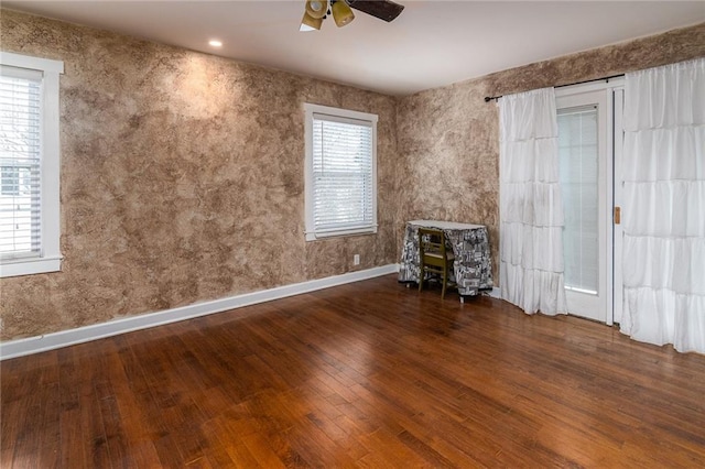 unfurnished living room with wood-type flooring and ceiling fan