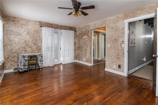 unfurnished living room with dark hardwood / wood-style floors and ceiling fan