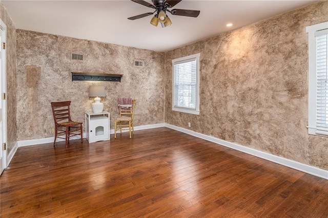 interior space featuring dark wood-type flooring and ceiling fan