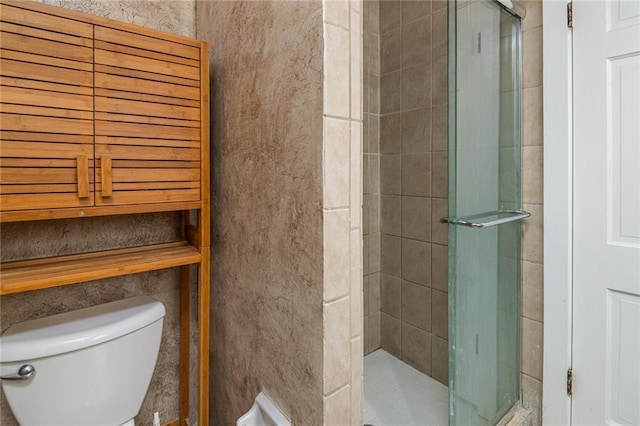 bathroom featuring walk in shower and toilet