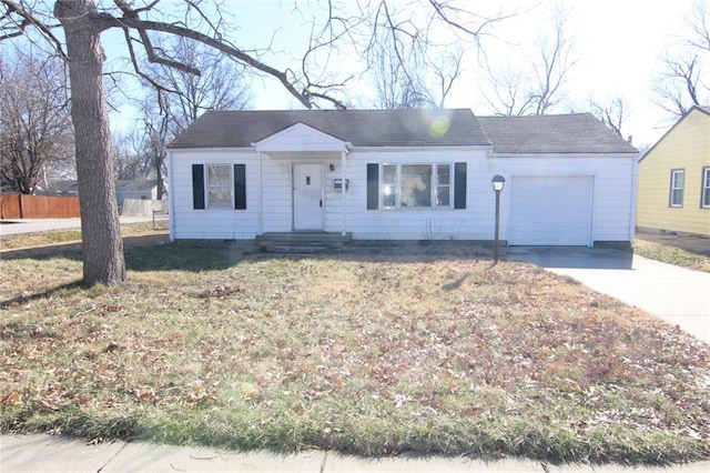 single story home featuring a garage and a front yard