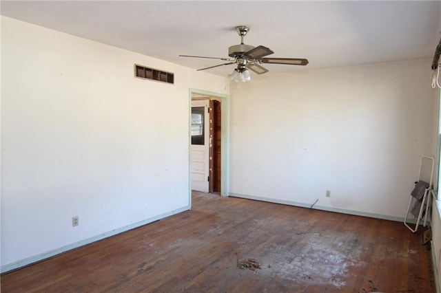 empty room with ceiling fan and dark hardwood / wood-style flooring