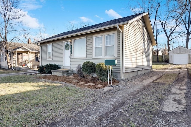 view of front facade with a garage, an outdoor structure, and a front yard