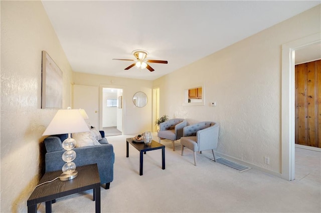 living room with light colored carpet and ceiling fan