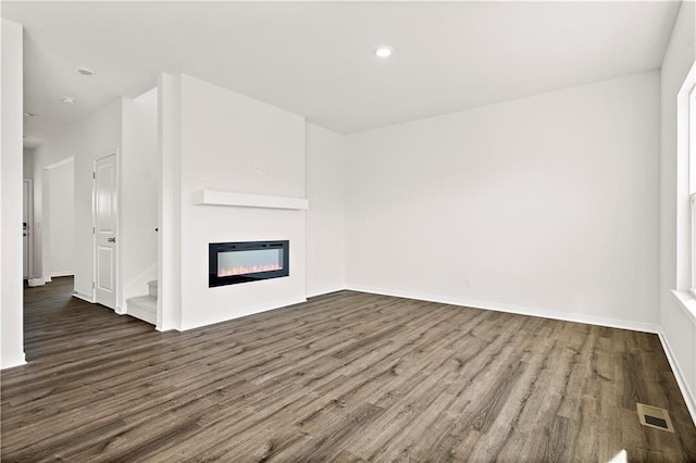 unfurnished living room with dark hardwood / wood-style flooring