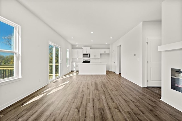 unfurnished living room with dark hardwood / wood-style floors