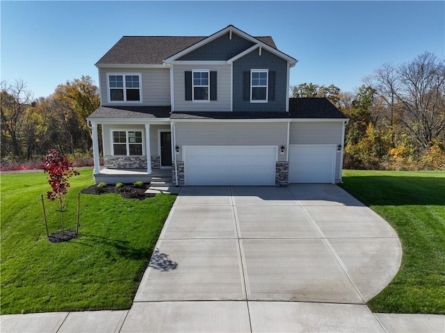 view of front facade with a garage, covered porch, and a front lawn