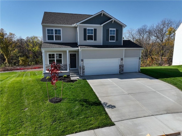 view of front facade with a porch, a garage, and a front yard