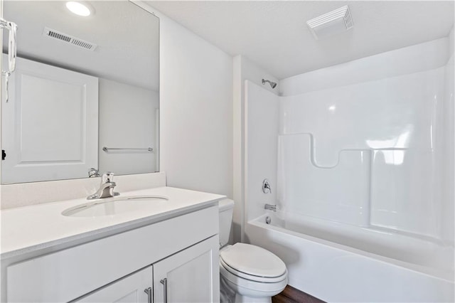 full bathroom featuring toilet, vanity, and  shower combination