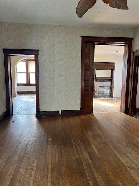 empty room featuring dark hardwood / wood-style flooring and ceiling fan