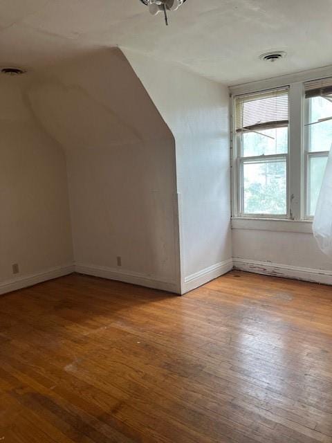 bonus room with hardwood / wood-style floors