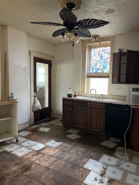 kitchen with ceiling fan, sink, a textured ceiling, and dark brown cabinetry