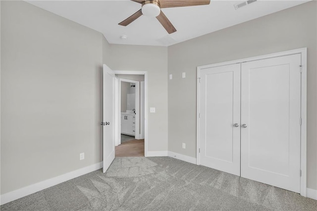 unfurnished bedroom featuring ceiling fan, carpet flooring, visible vents, baseboards, and a closet