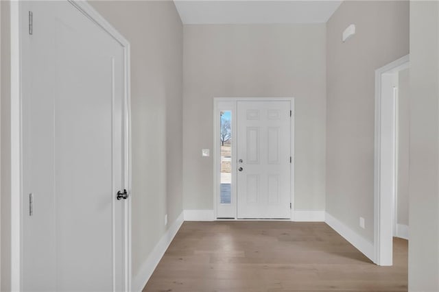 entrance foyer featuring baseboards and wood finished floors