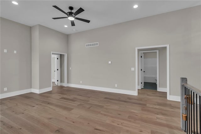 spare room with light wood-style floors, recessed lighting, visible vents, and baseboards