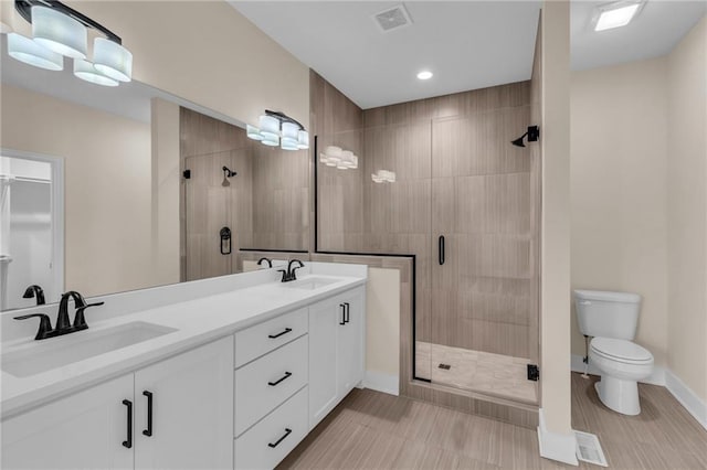 bathroom featuring a stall shower, a sink, and visible vents