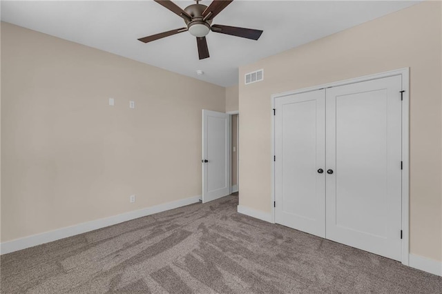 unfurnished bedroom with a ceiling fan, visible vents, baseboards, a closet, and carpet