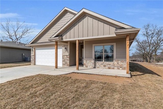 craftsman house featuring a garage, concrete driveway, stone siding, central air condition unit, and board and batten siding