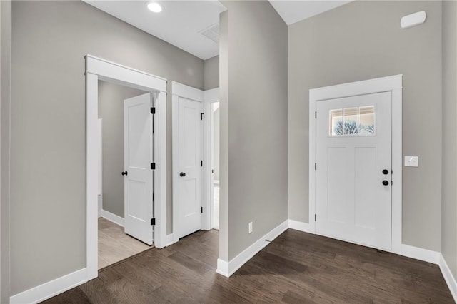 entrance foyer with baseboards and wood finished floors