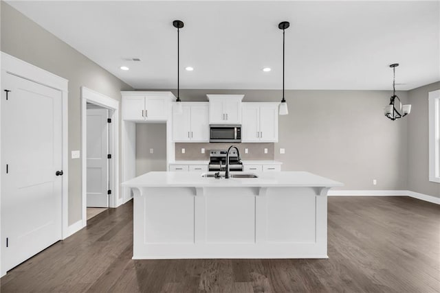 kitchen with visible vents, appliances with stainless steel finishes, light countertops, white cabinetry, and a sink