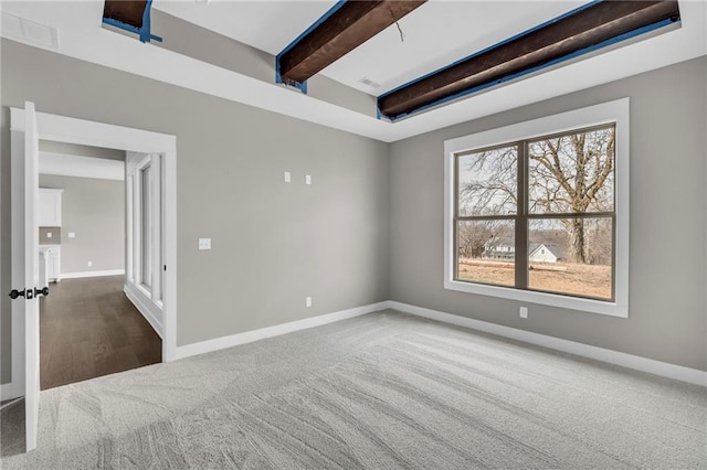 carpeted empty room featuring visible vents, baseboards, and beam ceiling