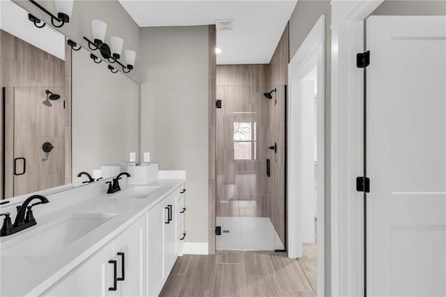 full bath with double vanity, a sink, and a shower stall