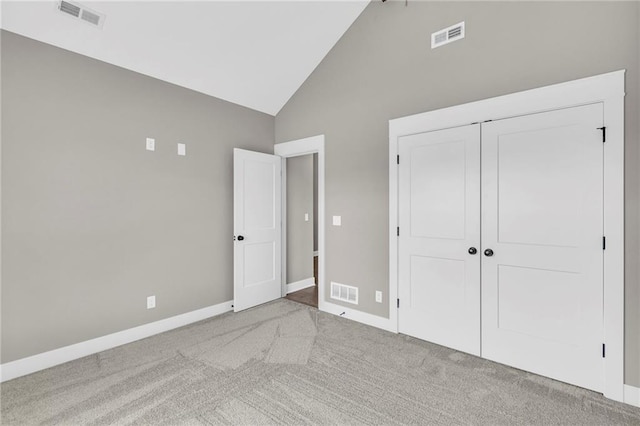 unfurnished bedroom with high vaulted ceiling, visible vents, and carpet flooring