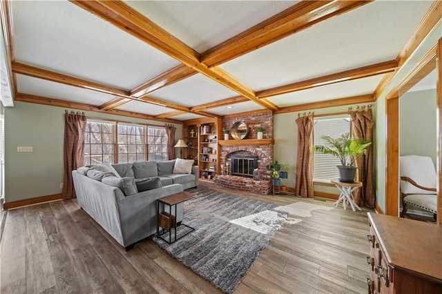 living room with coffered ceiling, a healthy amount of sunlight, and hardwood / wood-style floors