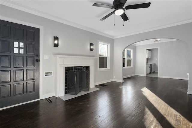 unfurnished living room with a fireplace, ornamental molding, dark hardwood / wood-style floors, and ceiling fan