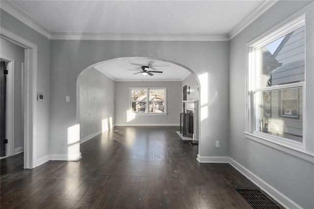 unfurnished living room with ornamental molding, dark hardwood / wood-style floors, and ceiling fan