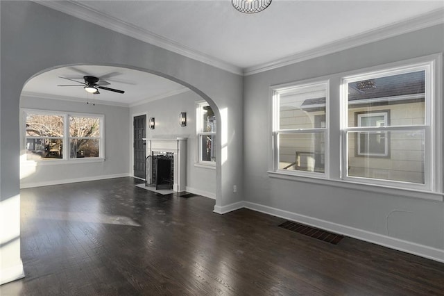 unfurnished living room with ornamental molding, dark hardwood / wood-style floors, and ceiling fan