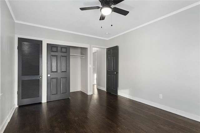 unfurnished bedroom with crown molding, ceiling fan, dark hardwood / wood-style flooring, and a closet