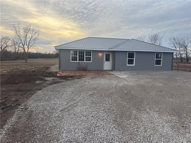 1202 NW County Road 6001, Butler, MO 64730 - view of front facade featuring metal roof and gravel driveway