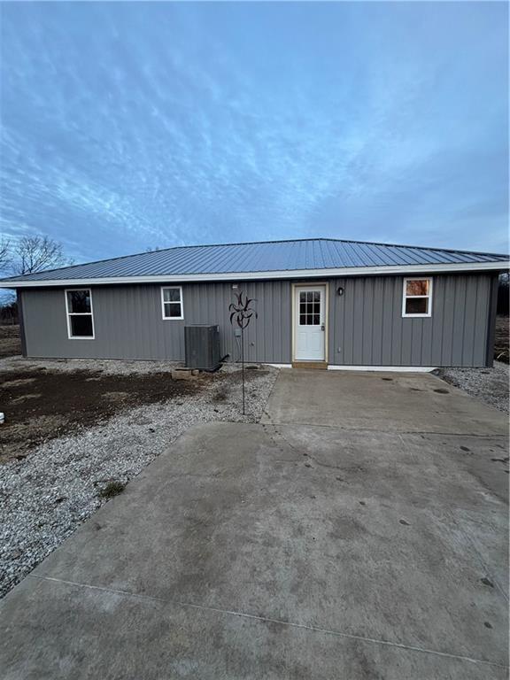 1202 NW County Road 6001, Butler, MO 64730 - view of front of home with central air condition unit and metal roof