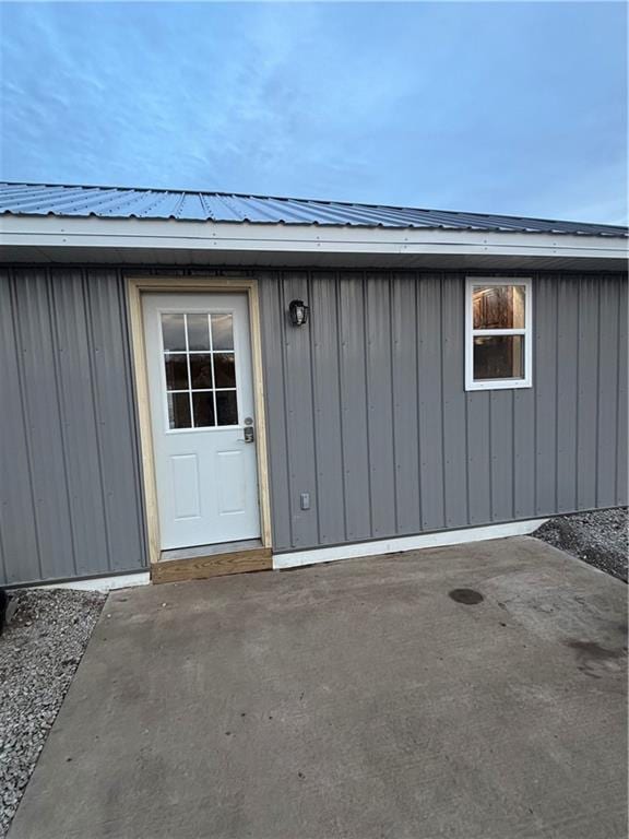 1202 NW County Road 6001, Butler, MO 64730 - view of exterior entry featuring metal roof, board and batten siding, and a patio area