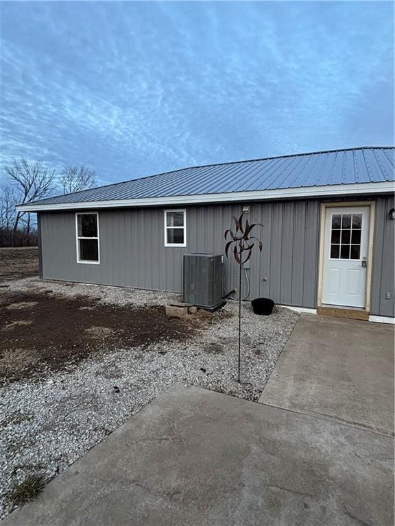 1202 NW County Road 6001, Butler, MO 64730 - view of side of home featuring central AC unit and metal roof