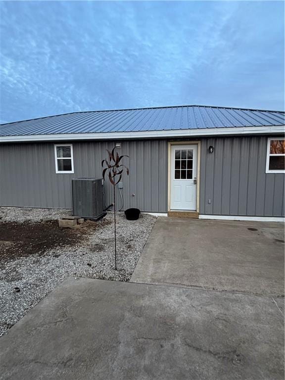 1202 NW County Road 6001, Butler, MO 64730 - entrance to property featuring cooling unit, metal roof, and board and batten siding
