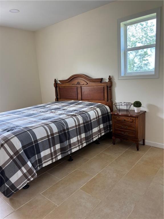1202 NW County Road 6001, Butler, MO 64730 - bedroom featuring light tile patterned floors and baseboards