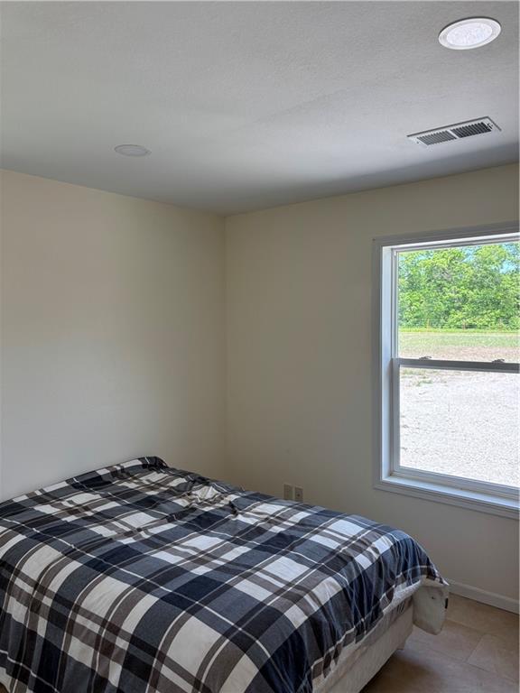 1202 NW County Road 6001, Butler, MO 64730 - bedroom featuring baseboards