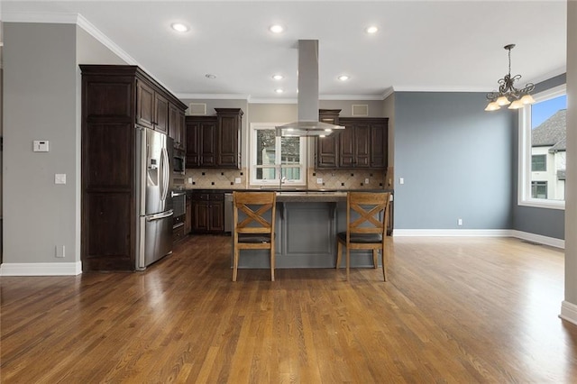 kitchen with dark wood-style flooring, stainless steel fridge, dark brown cabinets, and island range hood