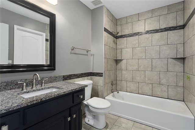 full bath with tile patterned flooring, toilet, visible vents, vanity, and tile walls